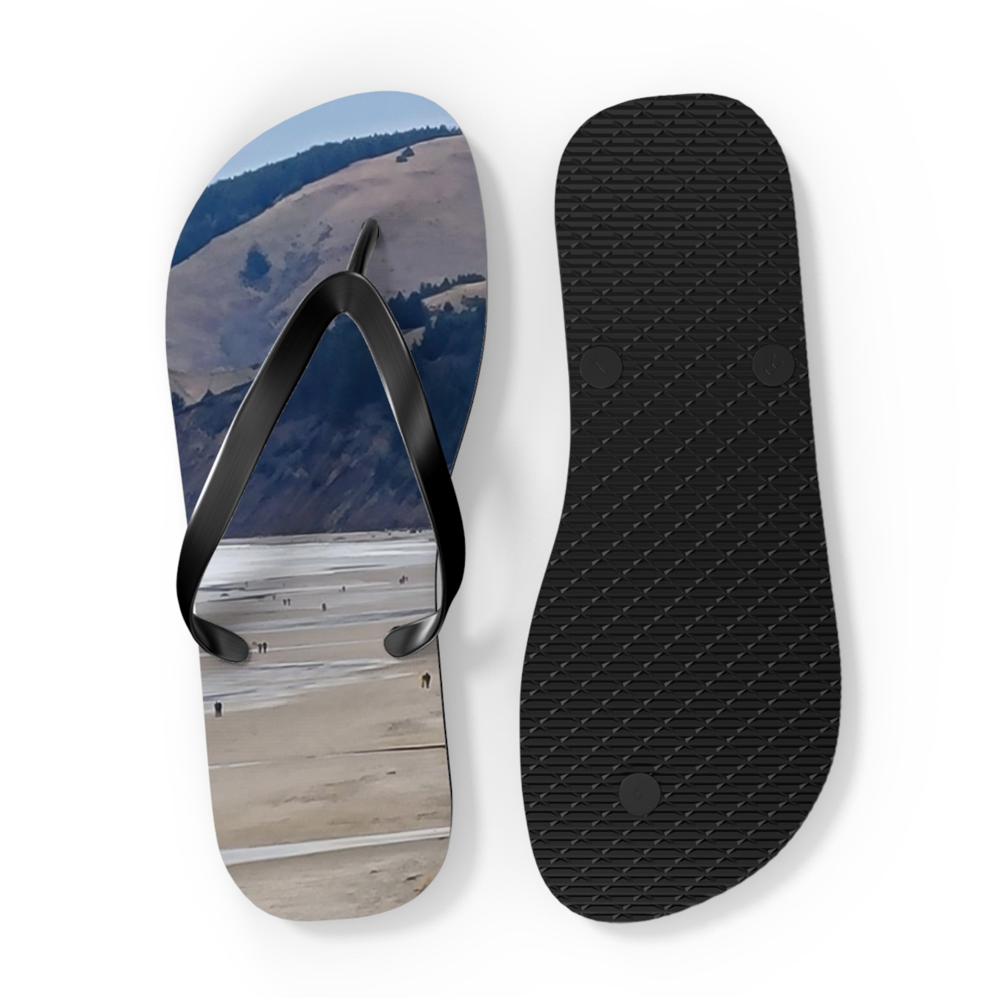 Flip-flops with beach scene on left, black textured sole on right.