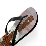 Flip-flop with "LAGUNA BEACH" text on a wood grain background.