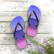Purple and pink gradient flip-flops with beach scene on wooden surface.