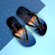 Flip-flops with "LAGUNA BEACH" text against a sunset and palm tree backdrop.