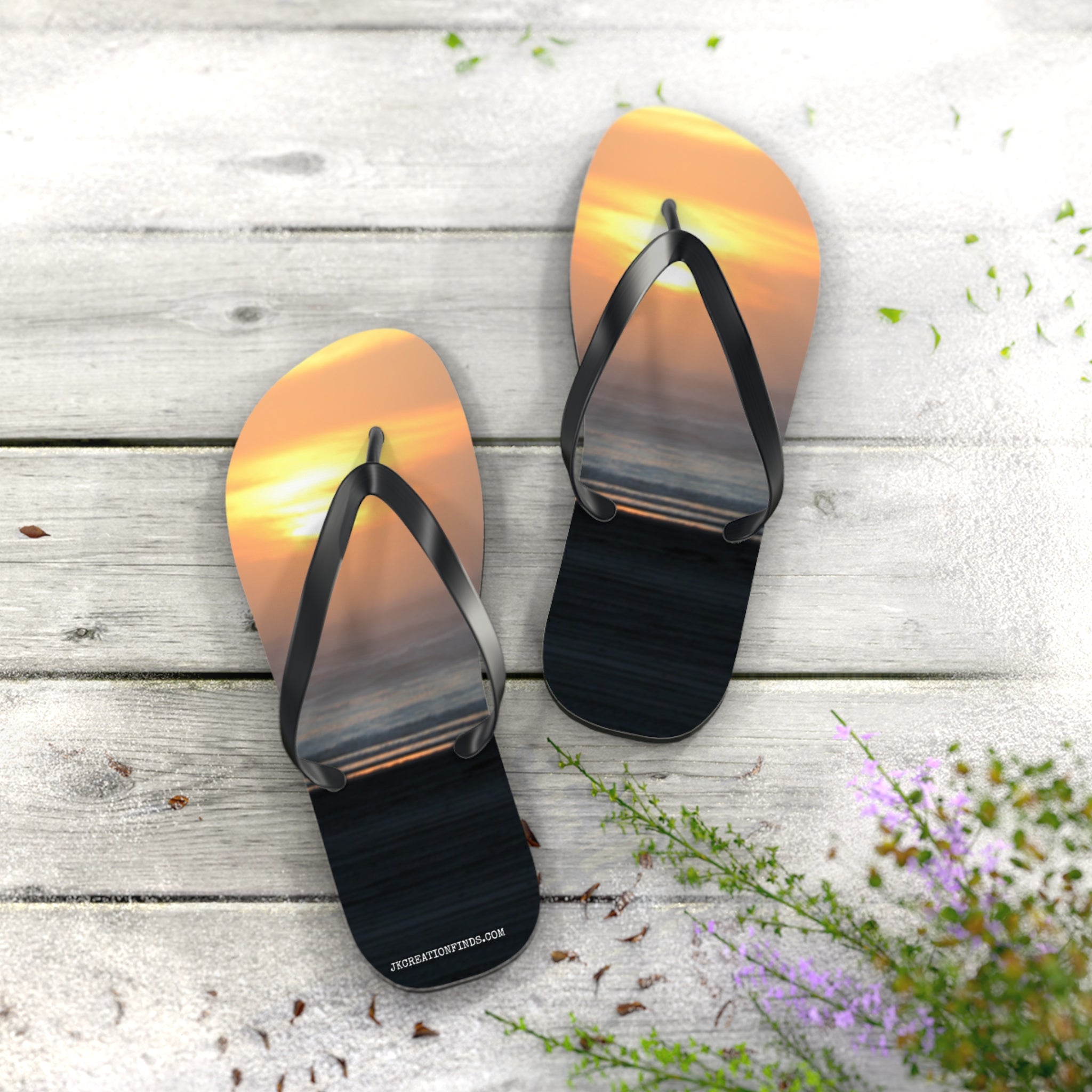 Flip-flops featuring a sunset over the ocean on a wooden deck.