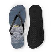 Flip-flops with a surfer on the sole and a black textured strap.