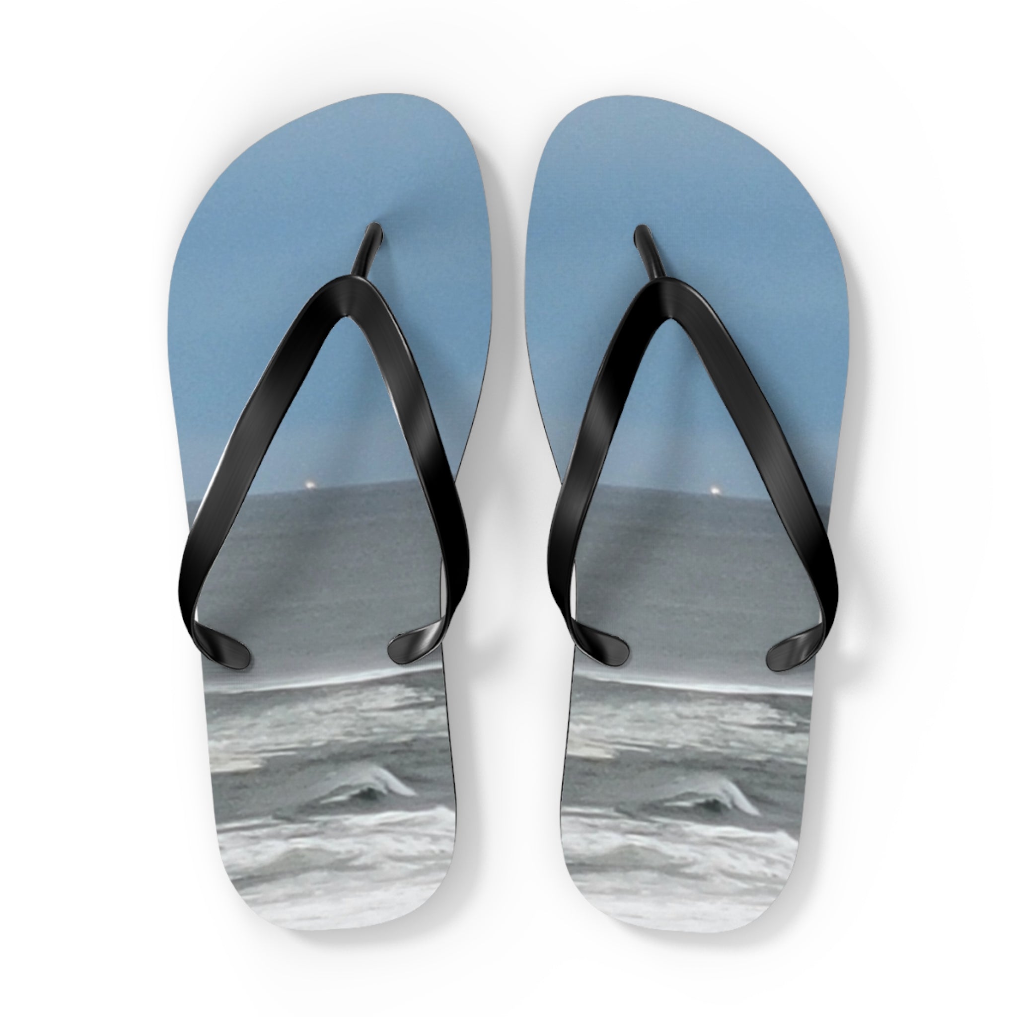 Blue flip-flops with a beach and ocean scene.