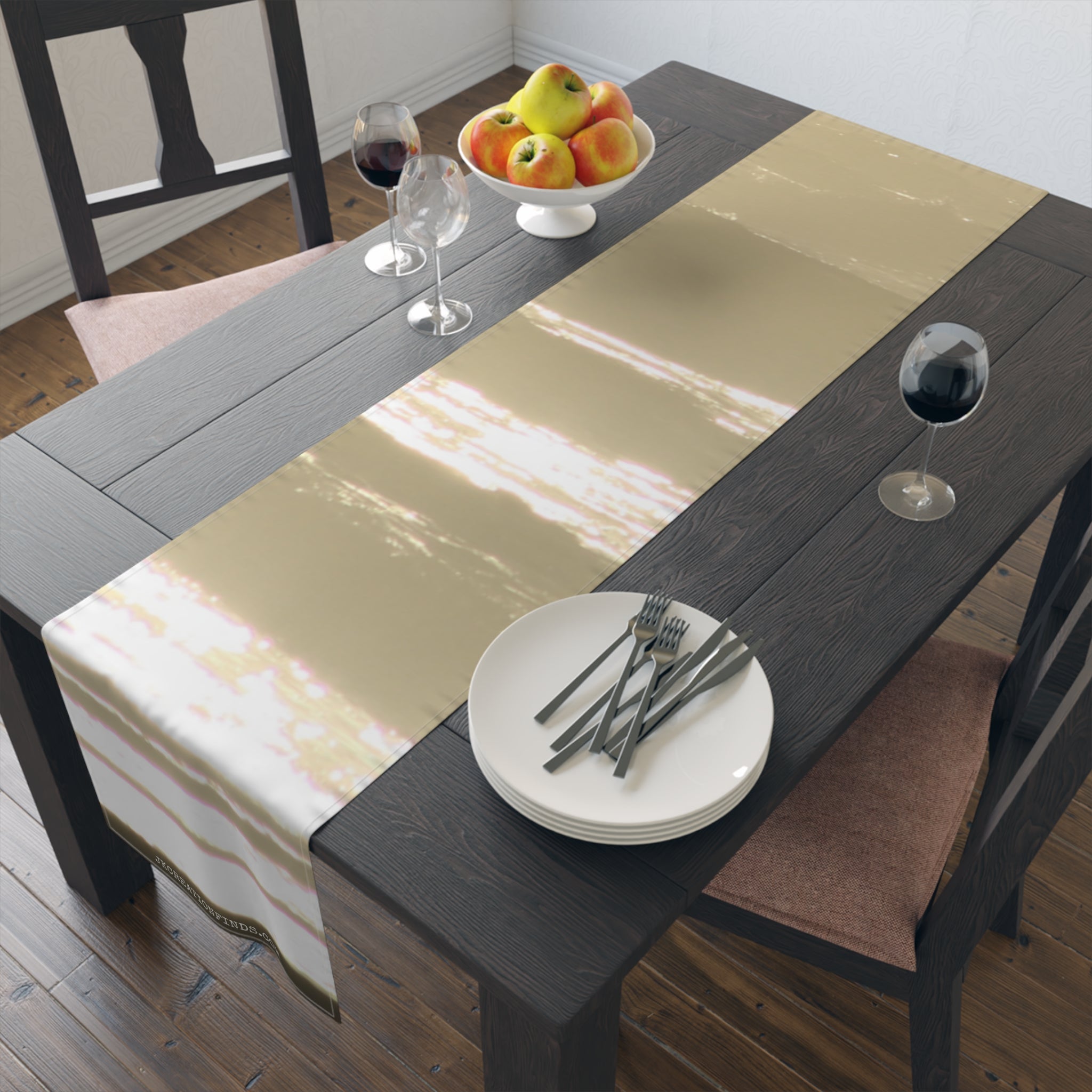 Table runner with abstract light brushstrokes over dark wood table with place setting.