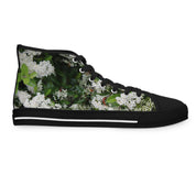 Black high-top sneaker with a floral white blossom and green leaf pattern.