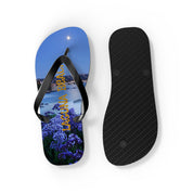 Flip-flops featuring a nighttime coastal view with "LAGUNA" in purple flowers.