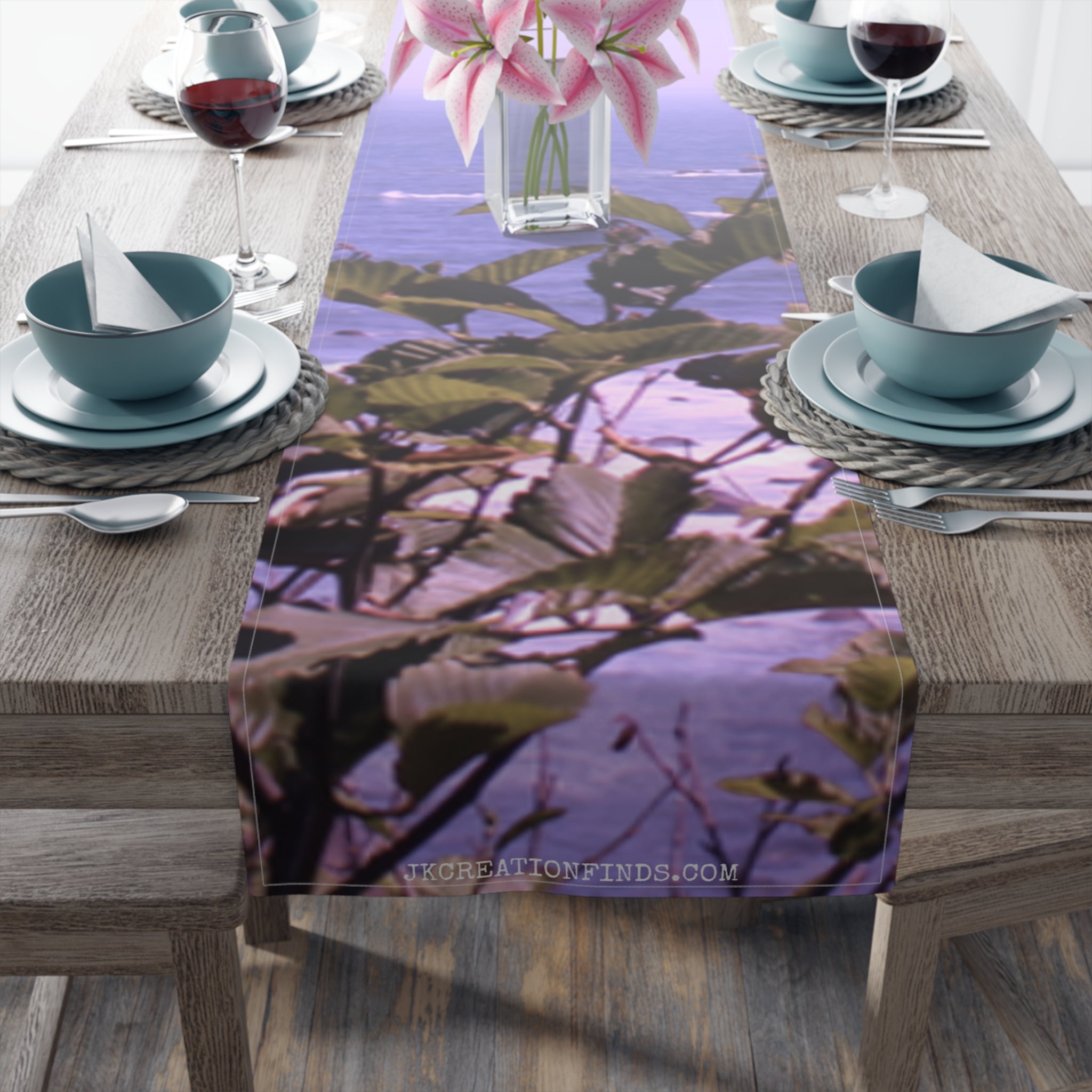 Table runner with purple lilies and green leaves pattern.