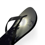 Black flip-flop with a moonlit forest scene printed on the sole.