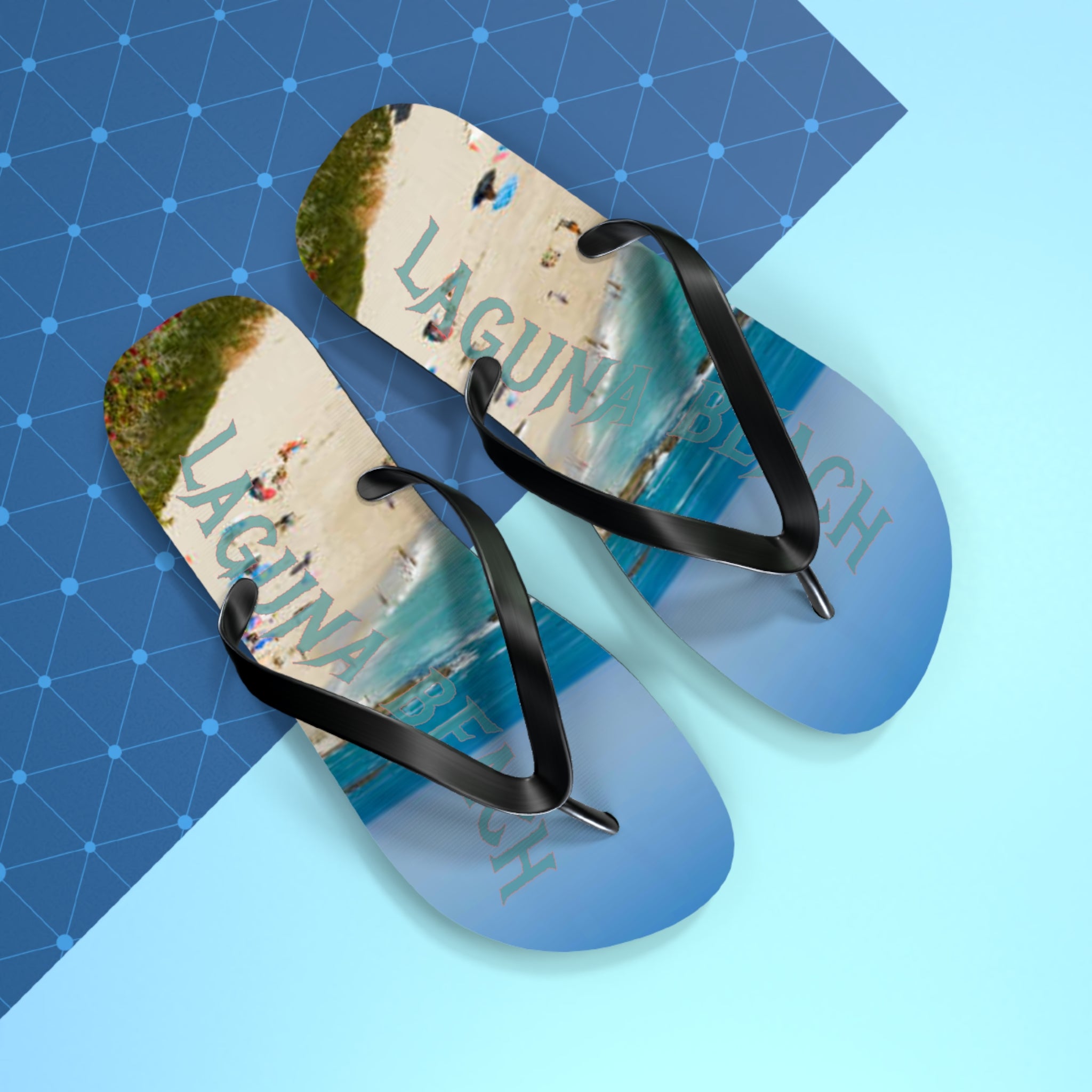 Flip flops with "LAGUNA BEACH" text on a light blue and dark blue patterned background.