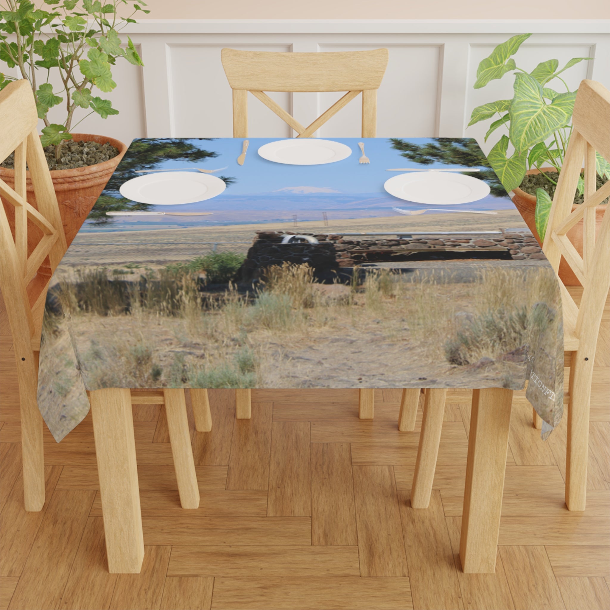 Tablecloth with a landscape scene of dry grass and mountains.