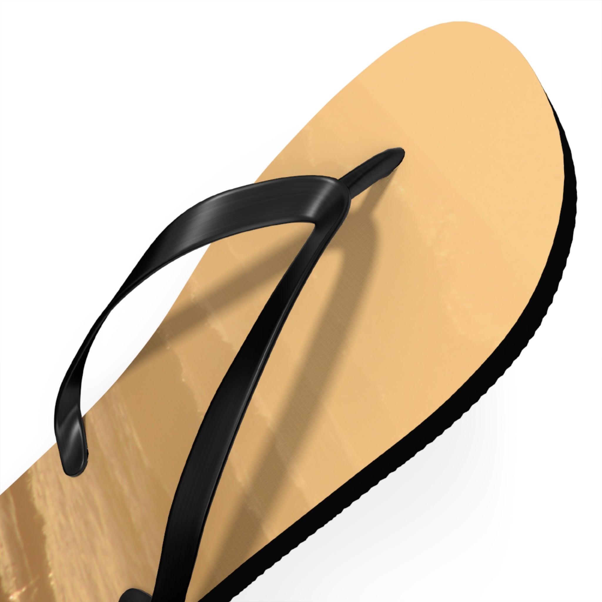 Tan flip-flop with black strap on white background.