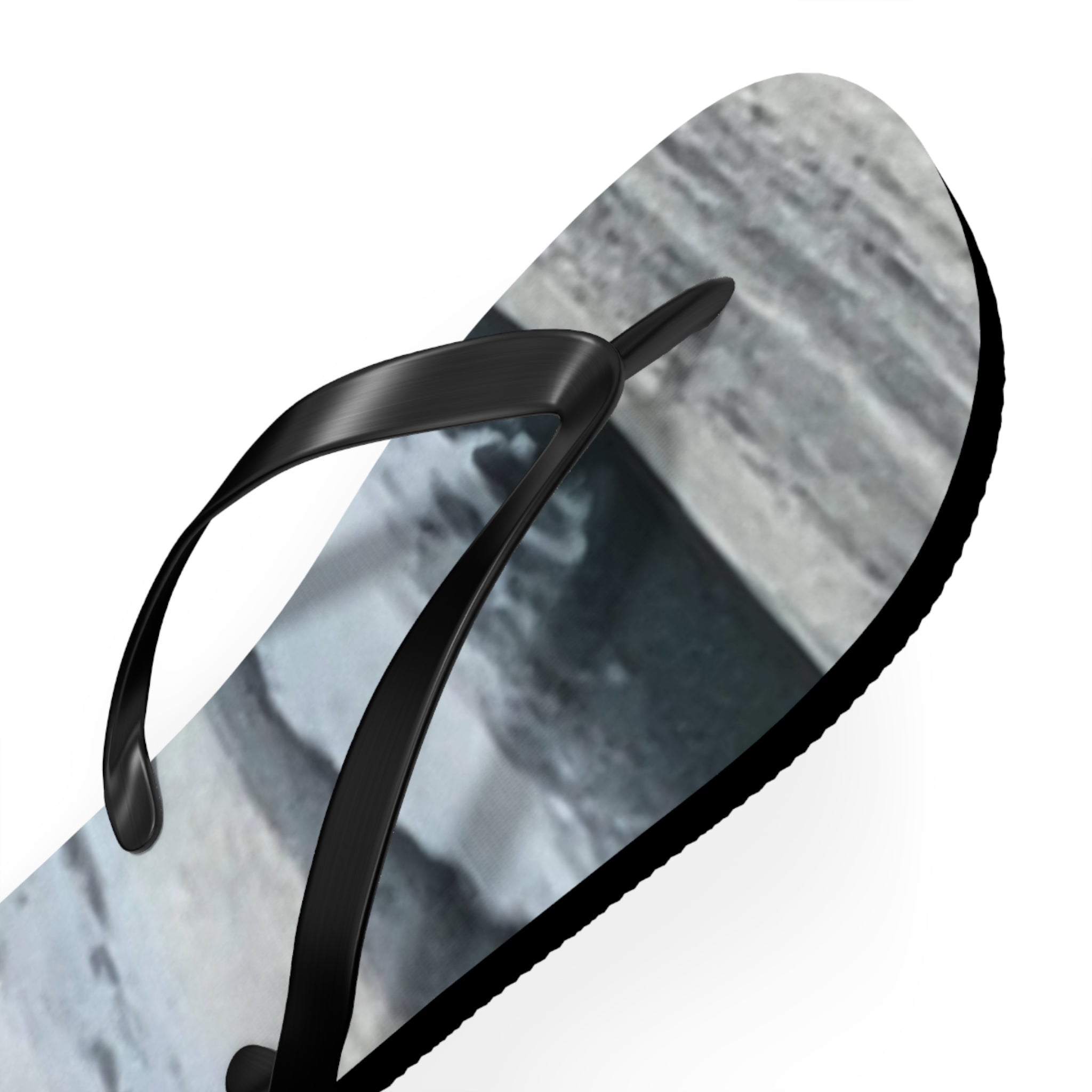 Black flip-flops with a grey and white marbled sole.