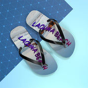 Flip-flops with "LAGUNA BEACH" text against a blue geometric background.