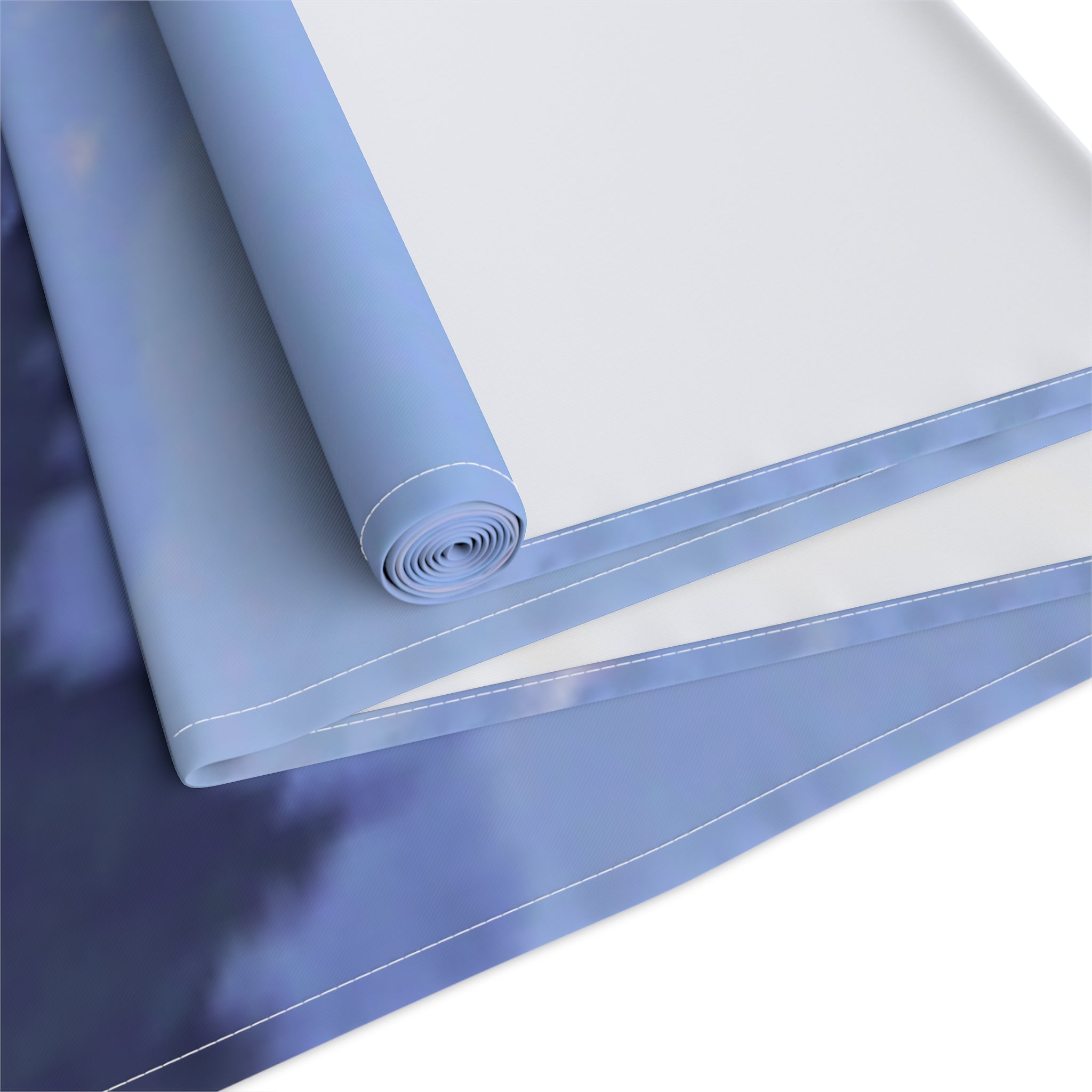 Rolled fabric with a cloudy sky pattern and blue trim.