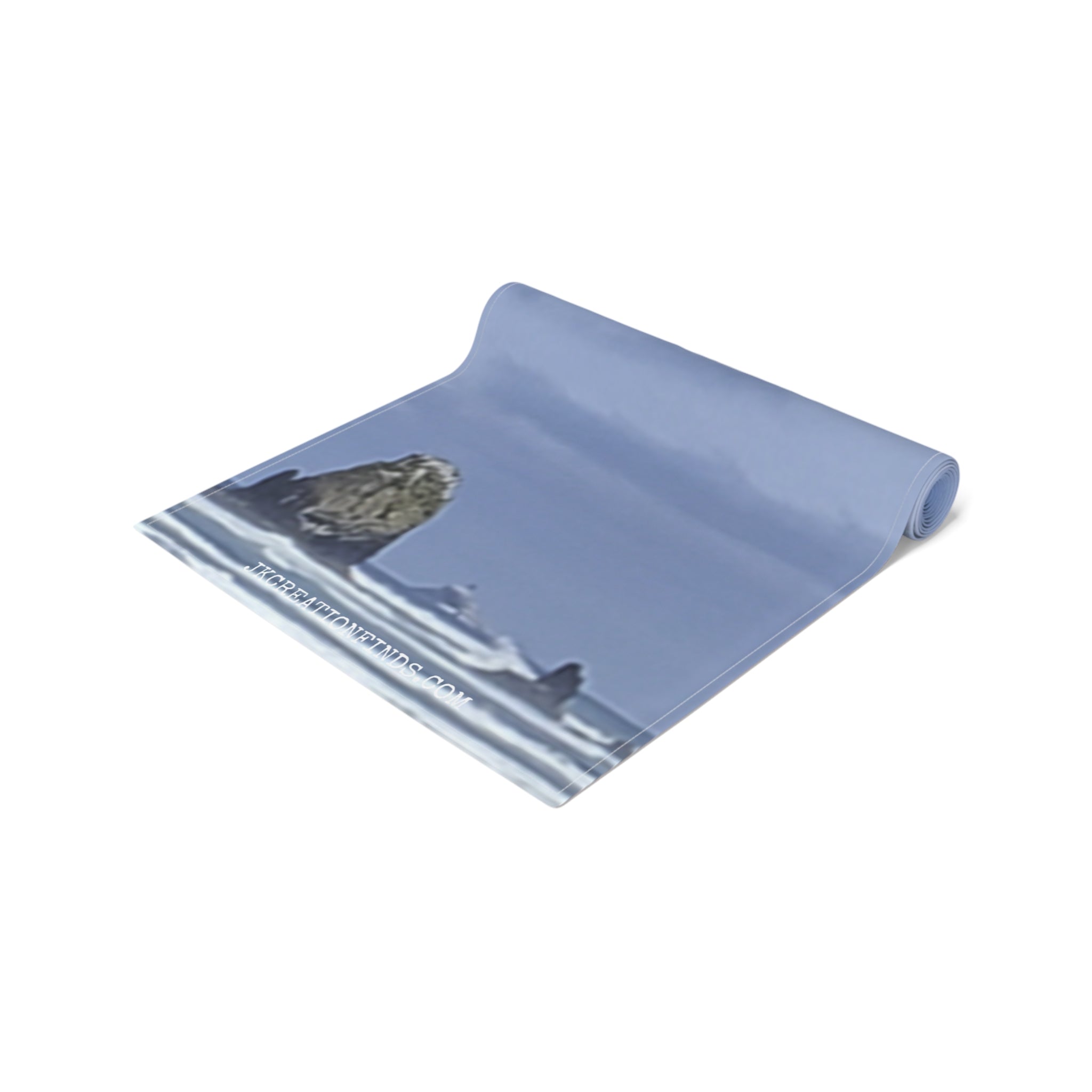 Rolled yoga mat with a rocky shore and ocean scene.