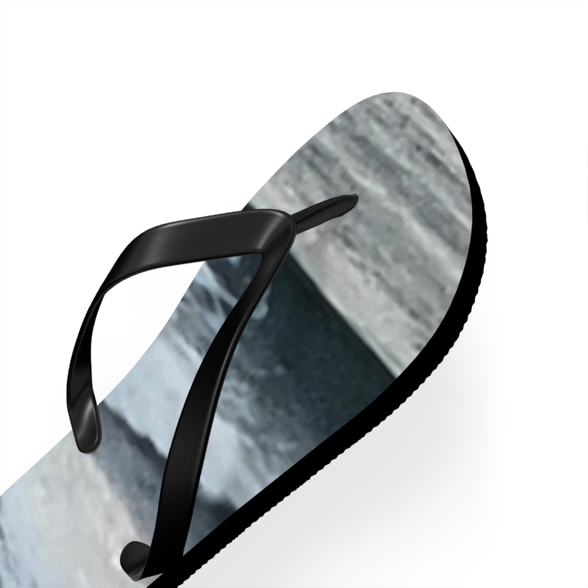 Black flip-flop with a marbled gray and white sole.