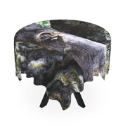 Round tablecloth with a tree bark pattern draped over a table.