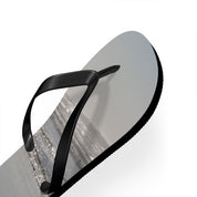 Black flip-flop with a beach scene printed on the sole.