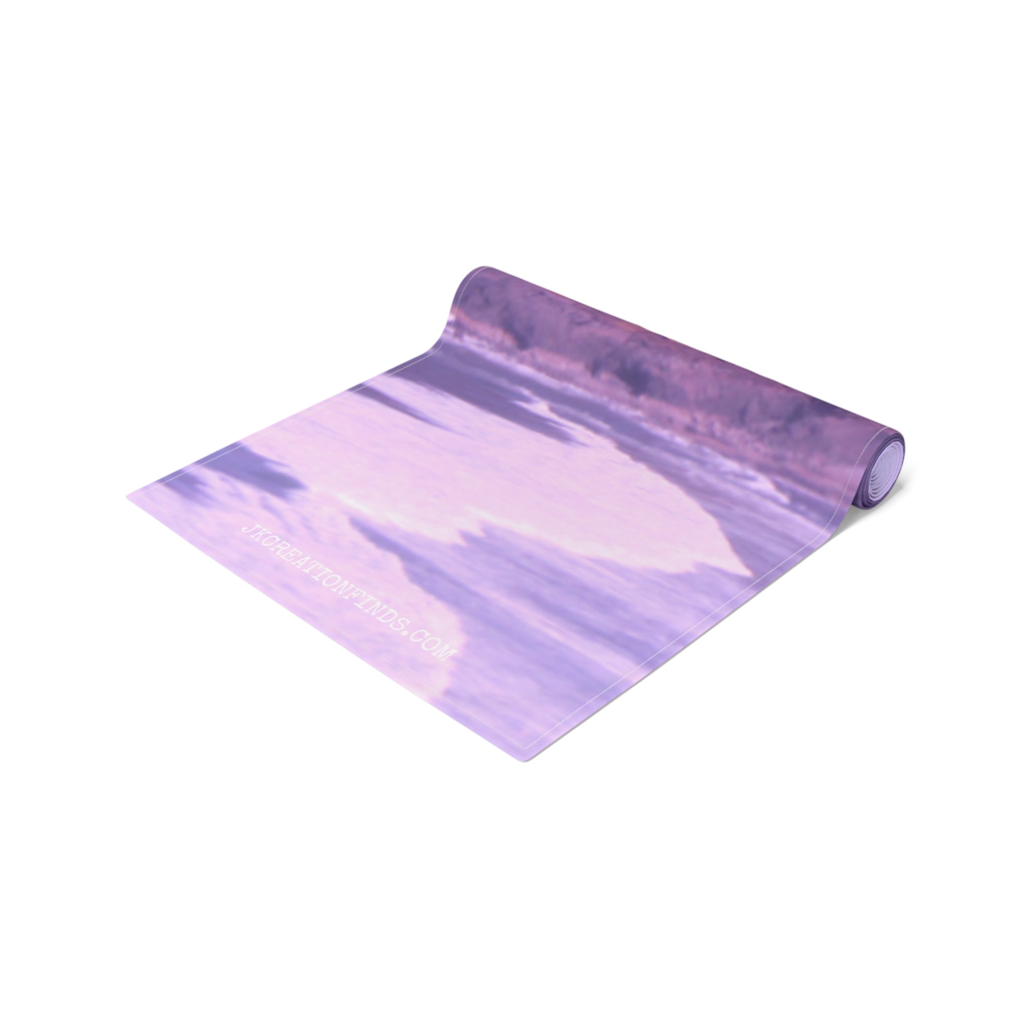Rolled yoga mat with purple abstract design and website URL.