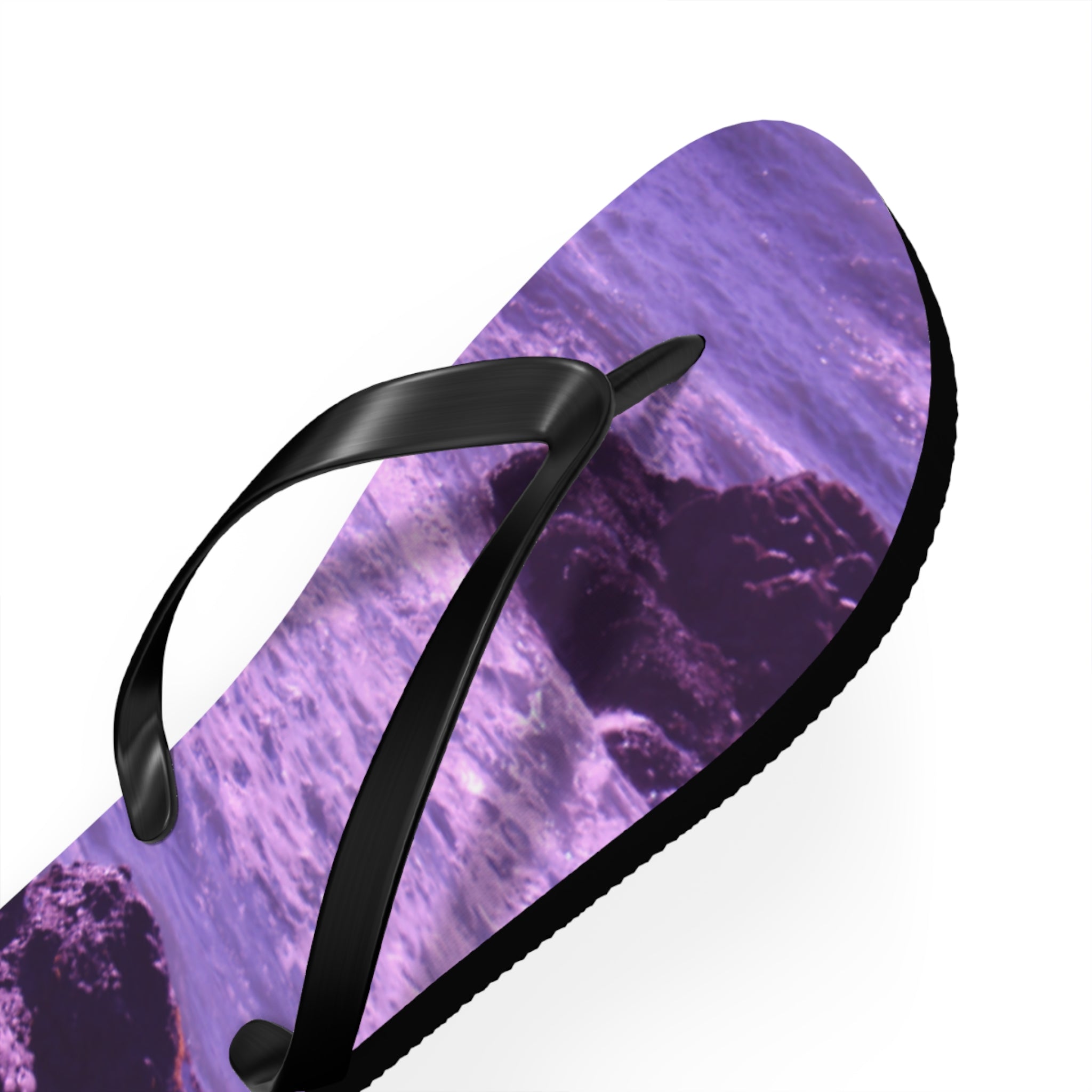 Purple flip-flop with ocean waves and rocks design.