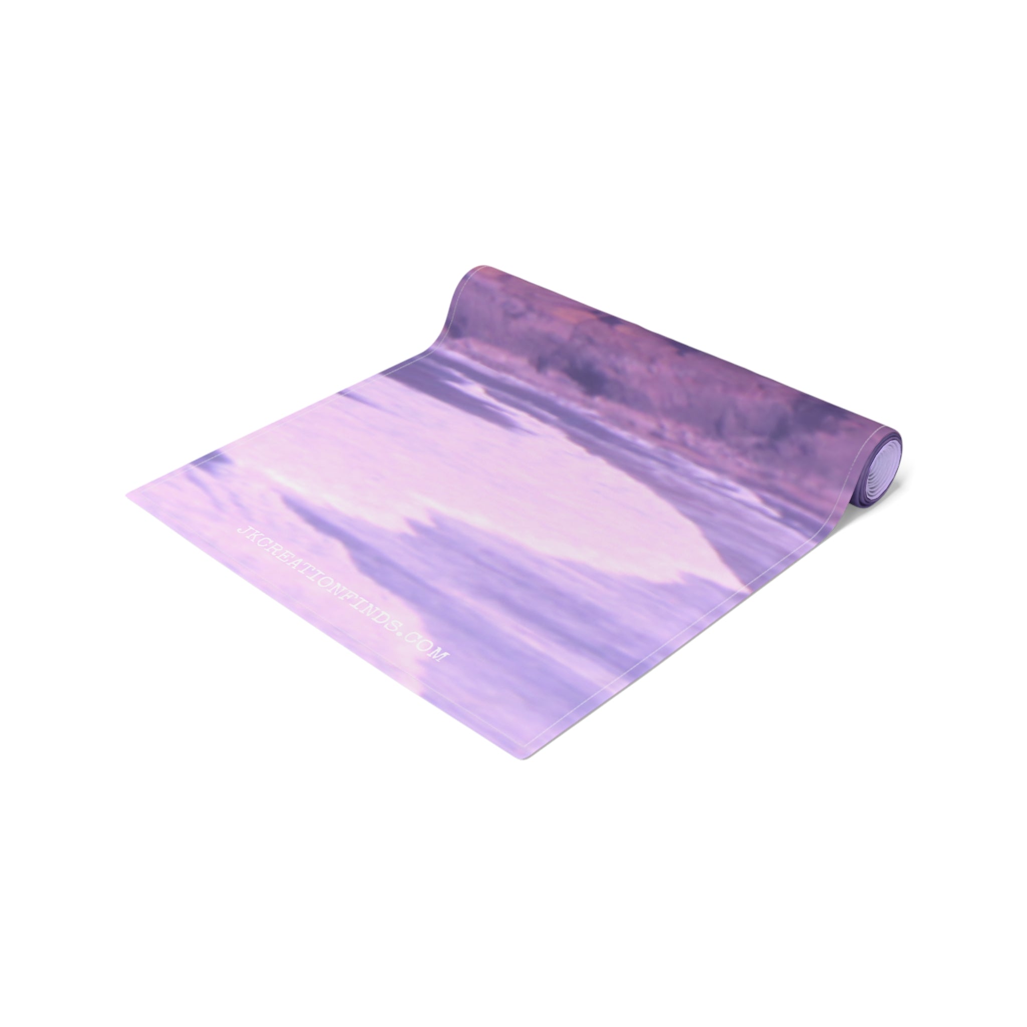 Rolled yoga mat with a pastel purple and white abstract wave pattern.