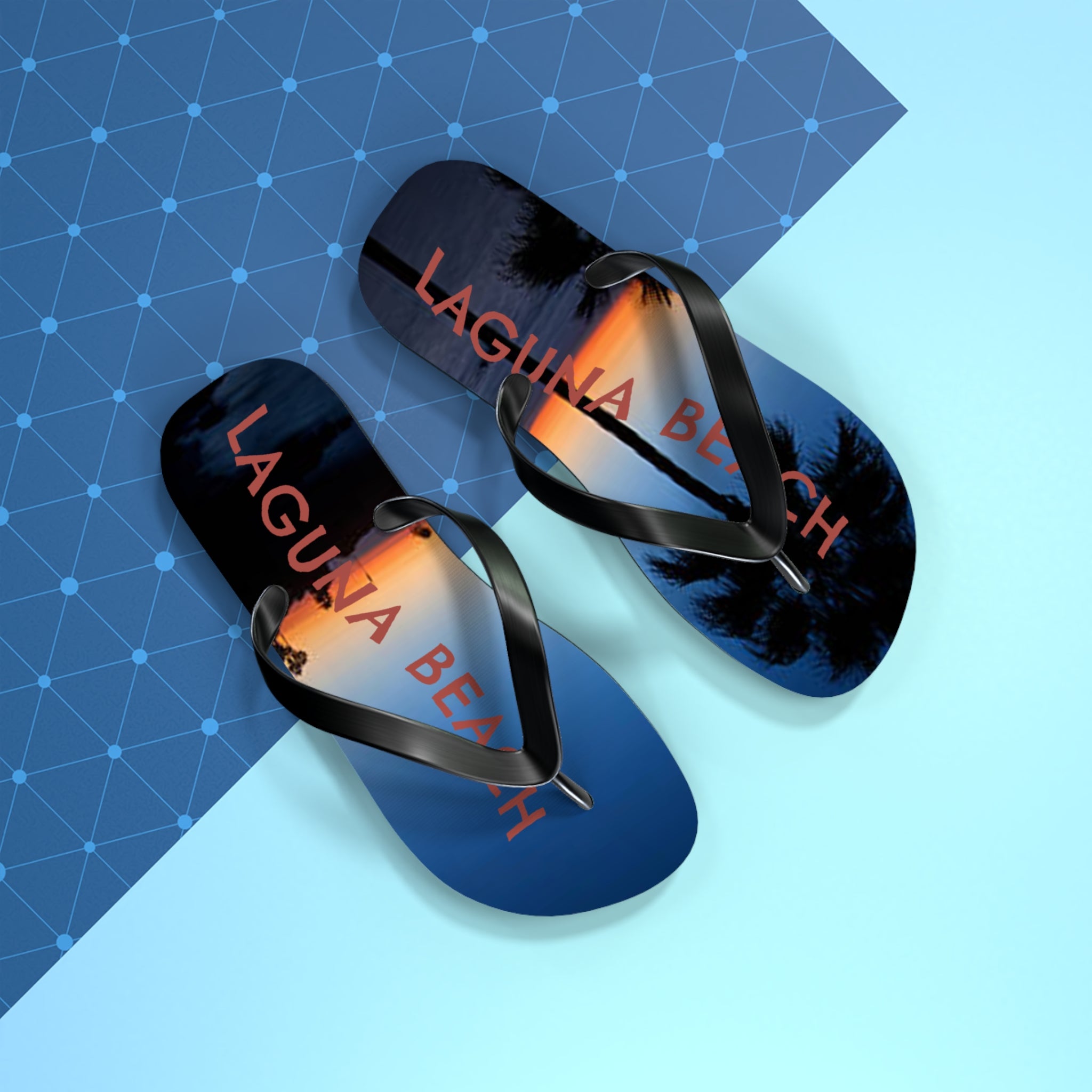 Flip flops with "Laguna Beach" text and palm trees at sunset.