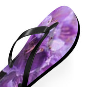Black flip-flop with a purple floral pattern.
