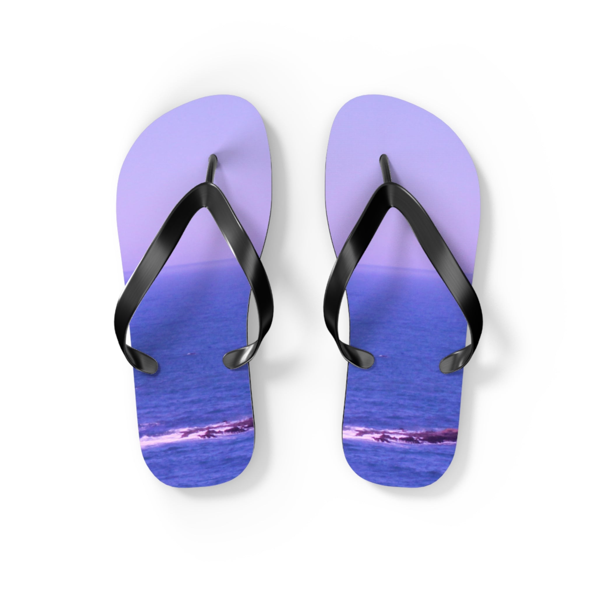 Purple flip-flops with a serene ocean view printed on the soles.