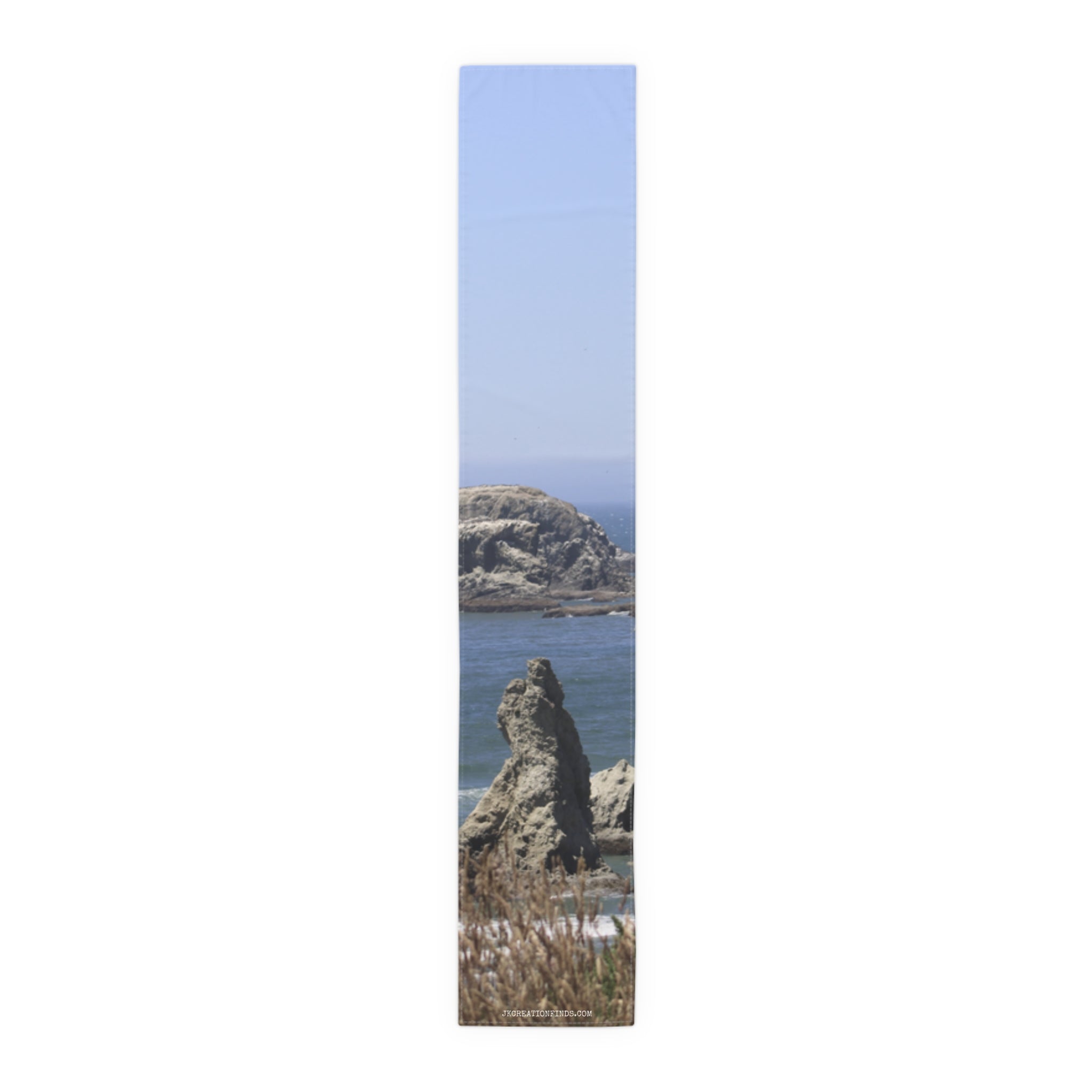 Tall, narrow artwork showing a rocky coastline with waves and dry grass.
