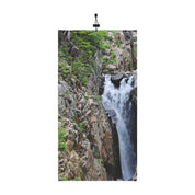 Majestic Waterfall Surrounded by Rocky Landscape Poster