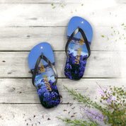 Flip-flops with a scenic view of Laguna Beach and purple flowers.