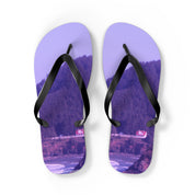 Purple flip-flops with a coastal landscape of houses and trees.