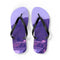 Purple flip-flops with a coastal landscape of houses and trees.