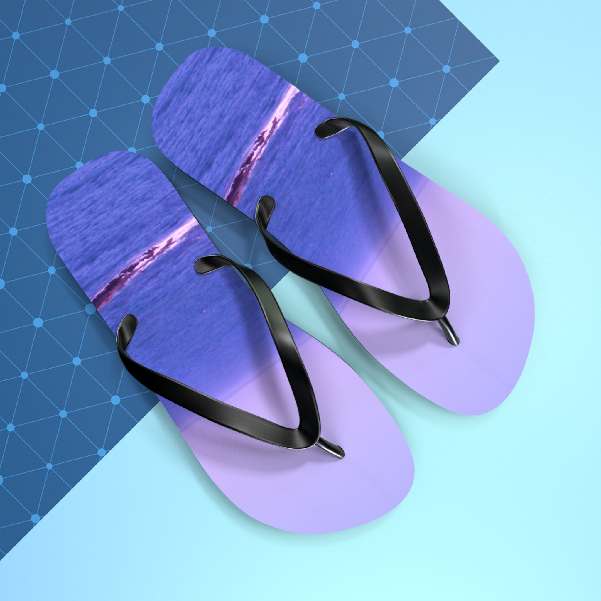 Purple and black flip-flops with a beach wave design on a blue background.