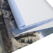 Rolled canvas fabric with a cloudy sky landscape print.
