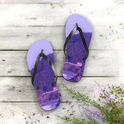 Purple flip-flops with a scenic mountain and house landscape printed on soles.