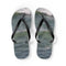 Pair of black flip-flops with ocean waves printed on the soles.