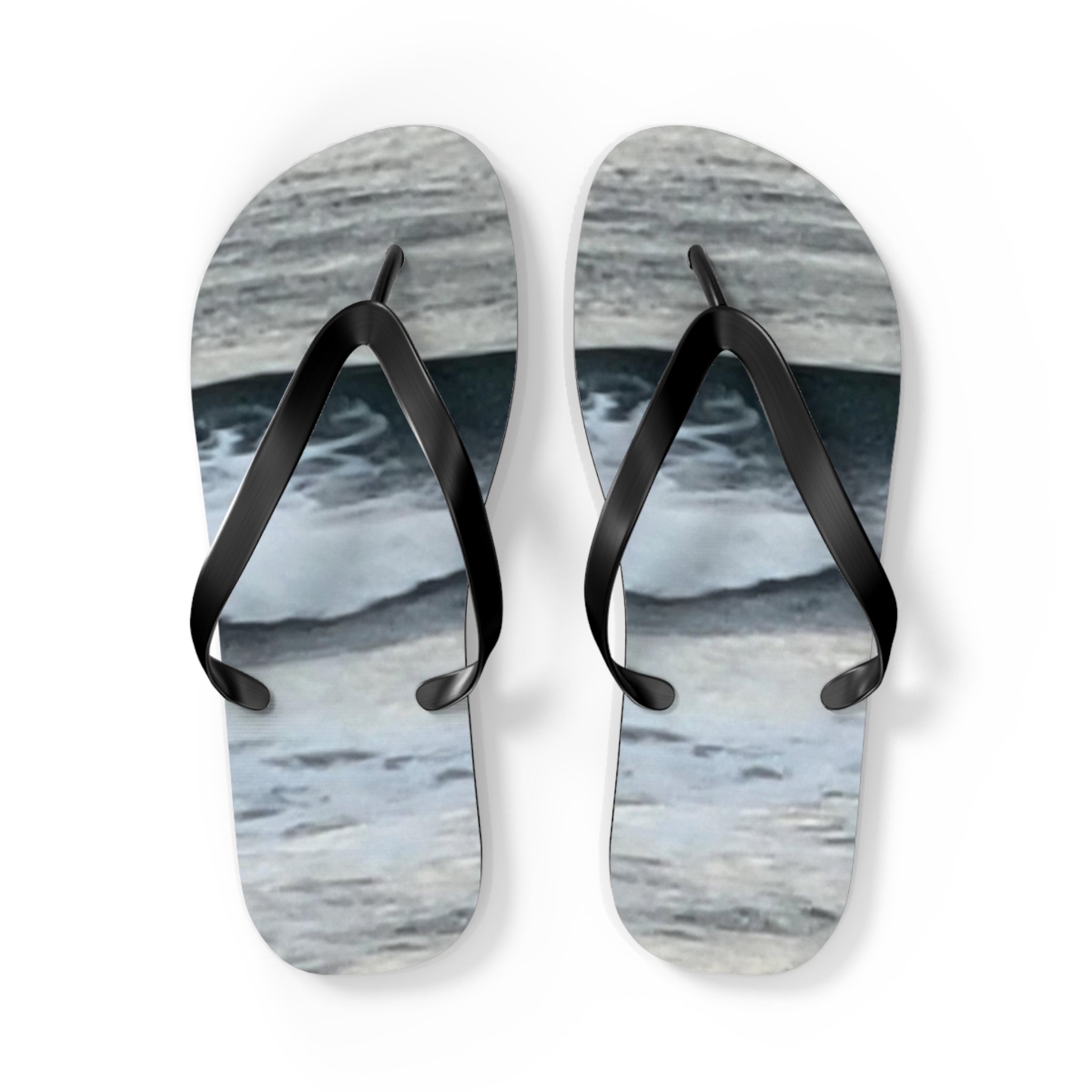White flip-flops with a wavy blue and grey pattern.