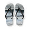 White flip-flops with a wavy blue and grey pattern.