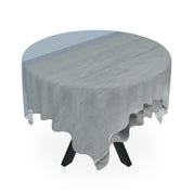 Round dining table with gray tablecloth and black legs.
