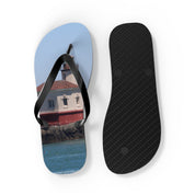 Flip-flops with a lighthouse on a rocky coast.