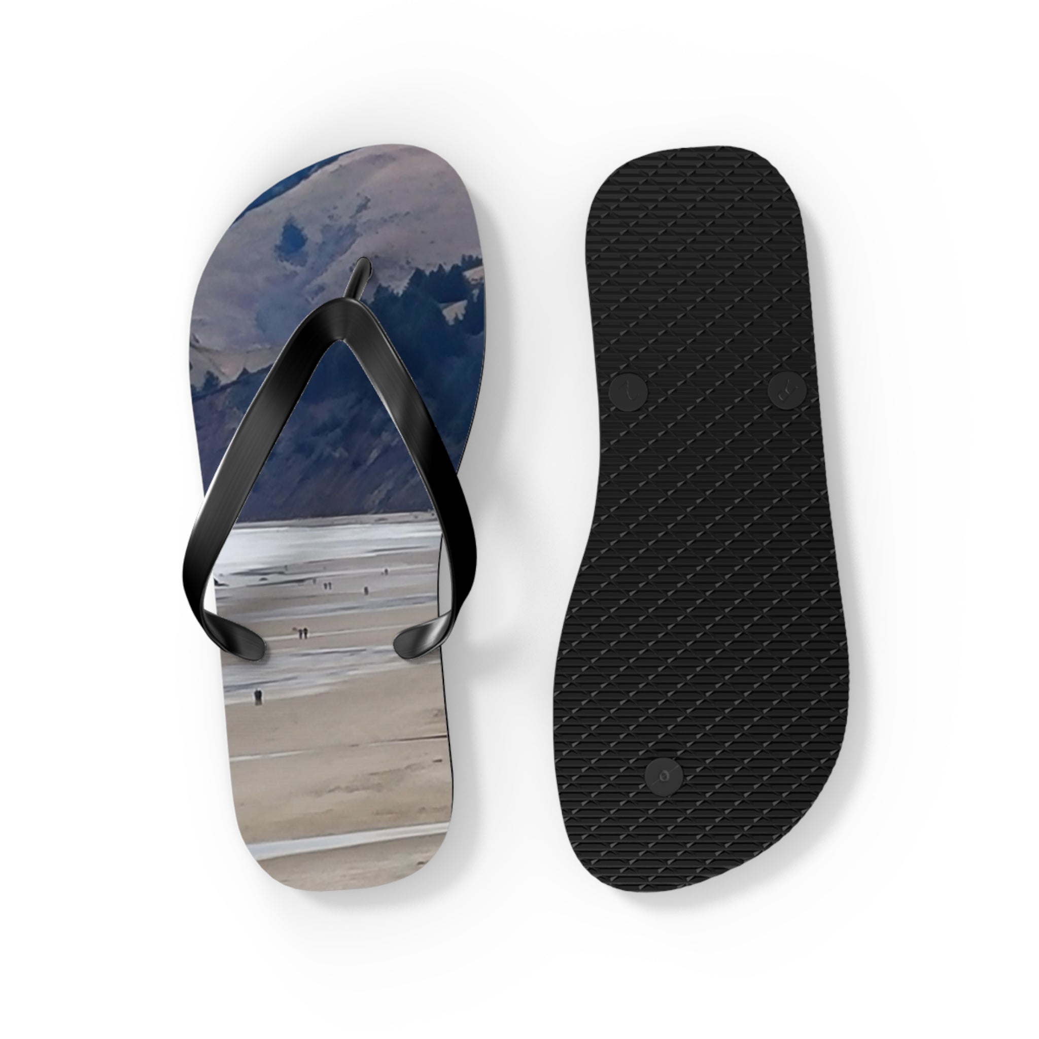 Flip-flops with a beach landscape on the soles, one shown from above, one from below.