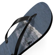 Black flip-flop with a textured blue sole featuring a blurred abstract design.