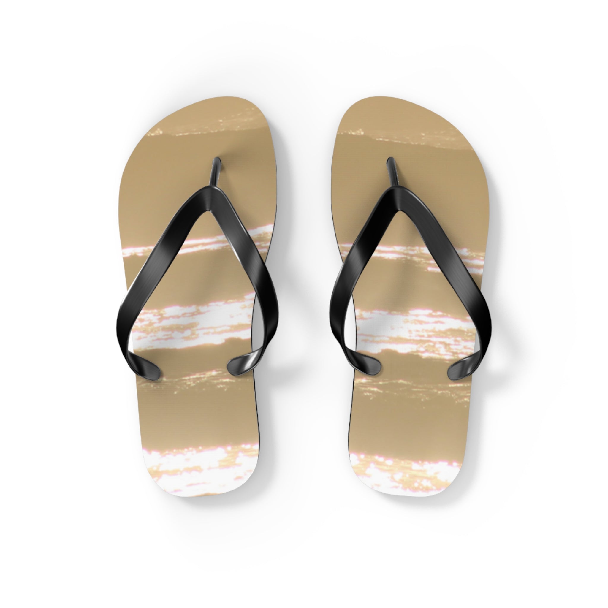 Tan flip-flops with black straps and a subtle reflective pattern on a white background.