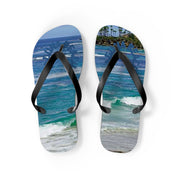 Flip-flops with a beach scene and wave graphic.