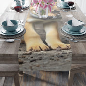 Shiba Inu dog paws on a table runner with pink flowers.