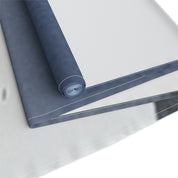 Rolled up blue tarp with white binding, ready for use.
