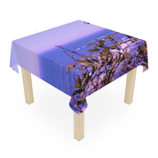 Tablecloth draped over a wooden table with a scenic ocean view.