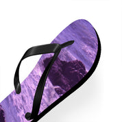 Purple ocean waves and rocks printed on a black and white flip-flop.