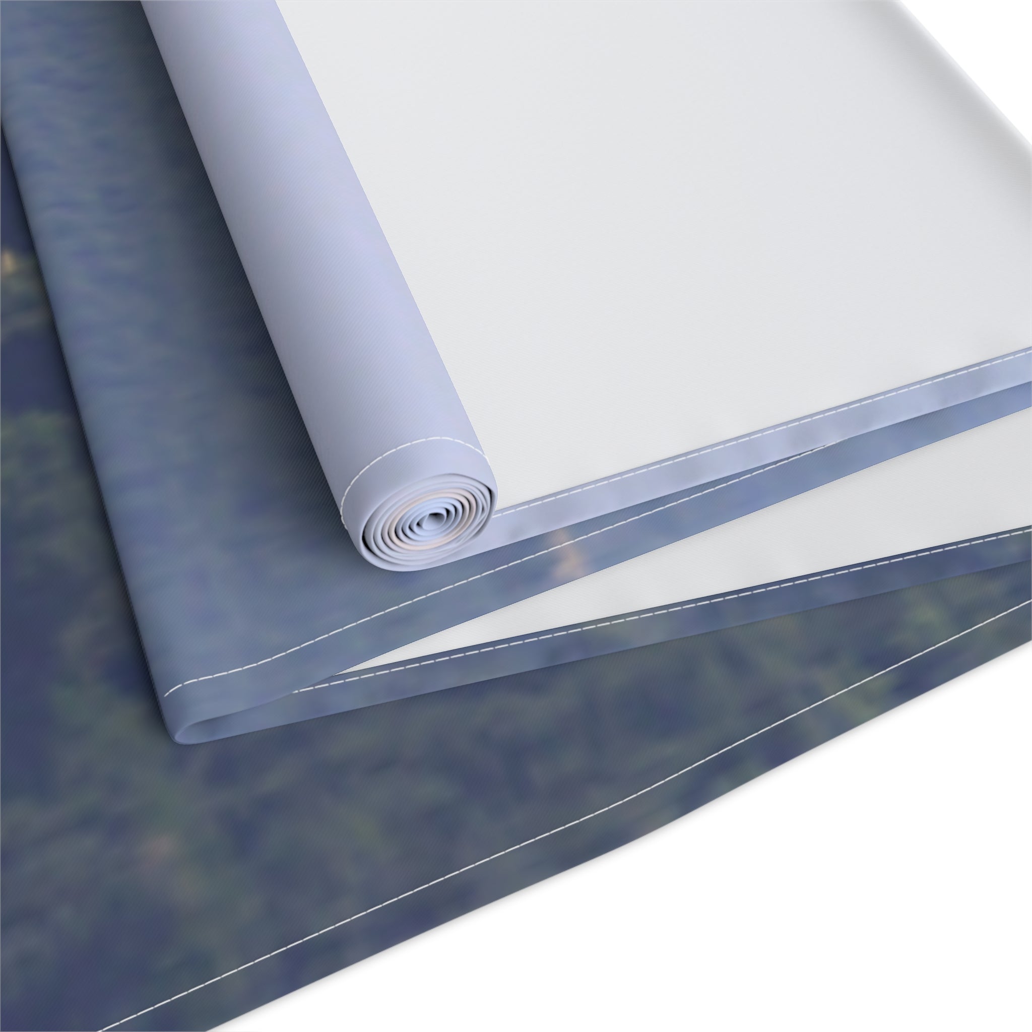 Rolled canvas with blurred forest scene, white background.
